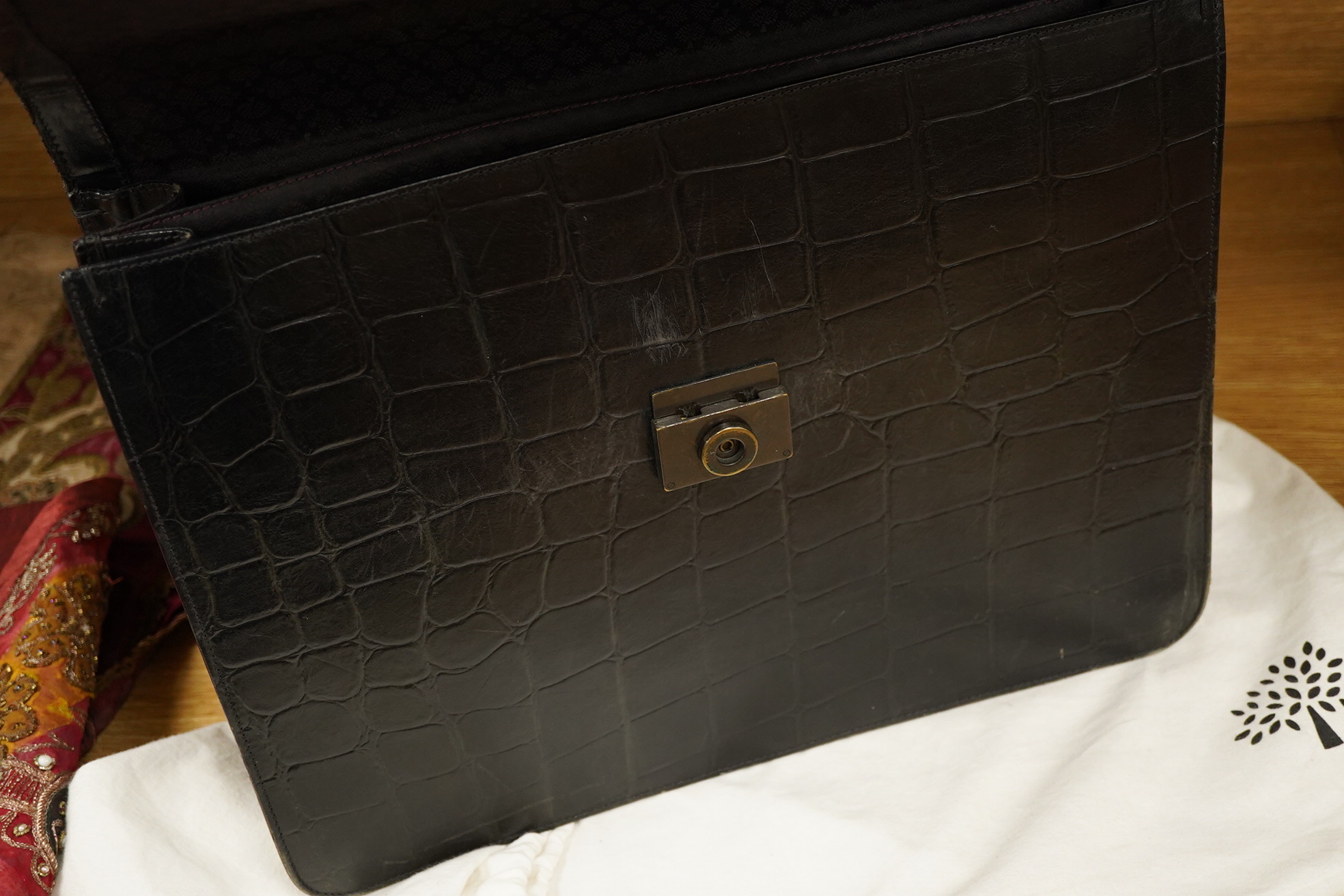 A faux crocodile black Mulberry briefcase, strap and dust cover, 41.5cm wide x 31cm high x 10cm deep at base. Condition - slightly rubbed on edges, needs a polish and lining cleaned